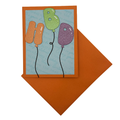 HBD balloon letters birthday card shown with orange envelope